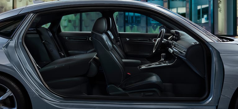 2027 Honda Civic Hatchback Touring Hybrid leather-trimmed seats with rear seat folded down (Compact Hatchback).